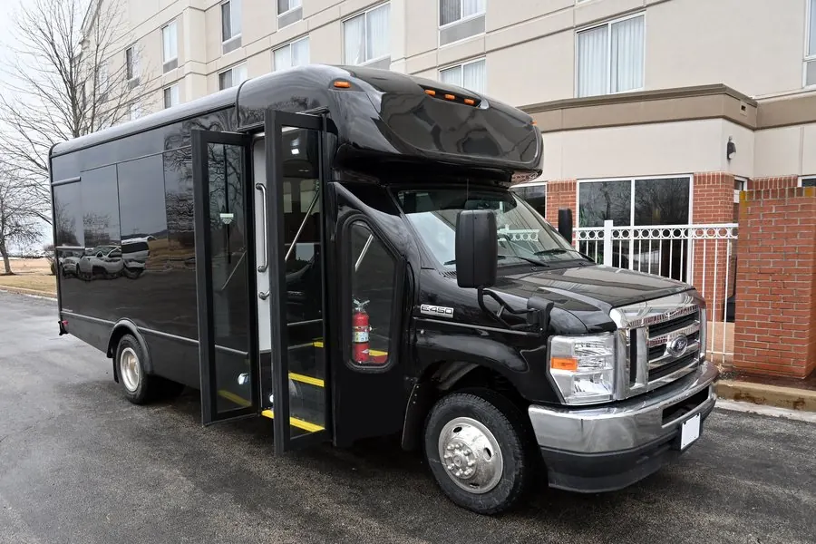 Black Umbrella Global Bus minibus staged at a hotel entrance